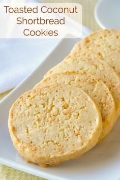 three toasted coconut shortbread cookies on a white plate with the words toasted coconut shortbread cookies