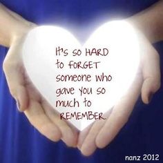 two hands holding a white heart with the words it's so hard to forget someone who gave you so much to remember