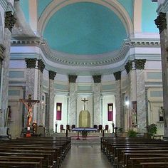 the inside of a church with pews and stained glass windows on either side of the alter