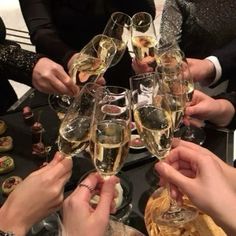 several people toasting with glasses of champagne