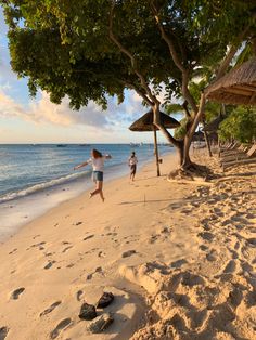 two people are running on the beach