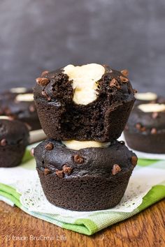 chocolate cupcakes stacked on top of each other with white frosting in the middle