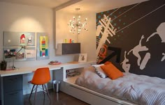 a bedroom with a bed, desk and chair in it's center area that has an art work on the wall