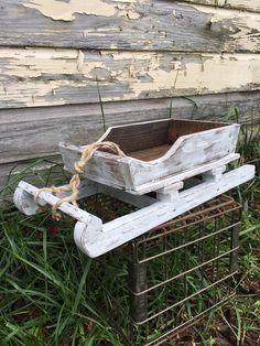 an old wooden sled with rope tied to it