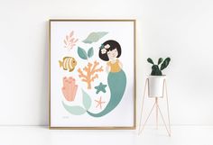 a poster with a mermaid and fish on it next to a potted plant in front of a white wall