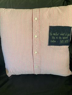 a red and white striped pillow with a black label on the front that says, no matter which is in this room