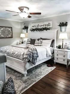 a large bed sitting inside of a bedroom on top of a hard wood flooring