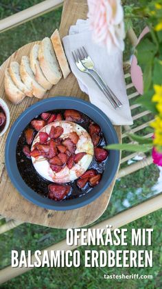 an image of a plate of food with bread on the side and flowers in the background