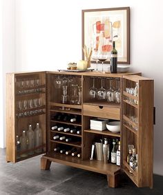 a wooden cabinet filled with lots of bottles and glasses