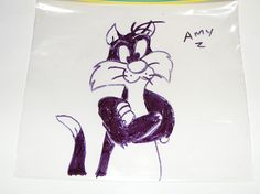 a drawing of a cat sitting on top of a white plate