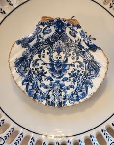 an ornate blue and white plate with gold trimmings on the edge is shown