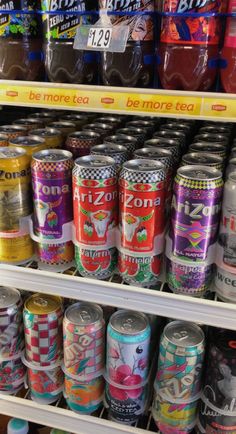 several cans of soda are on display in a store