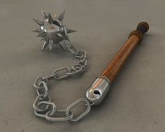 a metal chain with a wooden handle attached to it next to a silver object on the ground