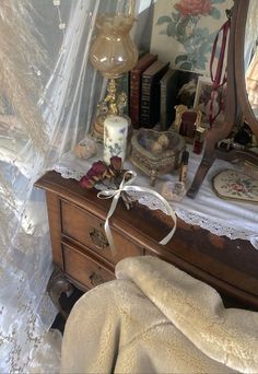 a bedroom with a dresser, mirror and other items on the table in front of it