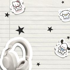 the headphones are on top of lined paper with stickers and stars around them