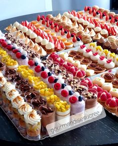 a table topped with lots of different types of desserts