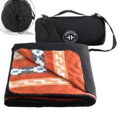 an orange and black blanket sitting on top of a bag