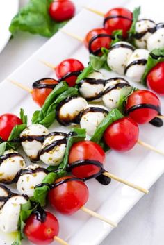 caprese salad skewers with tomatoes and mozzarella sauce on them