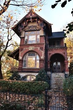 an old brick house with ivy growing around it