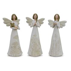 three white angel figurines with gold trimmings on them, one holding a cross