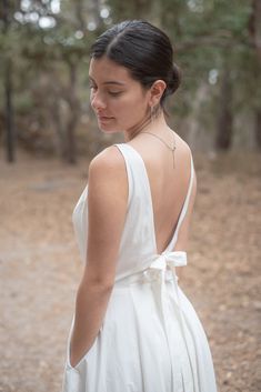 Gorgeous 100% Cotton Dress with Corton Lining.  The dress is off-white, has pockets, is backless with 2 ties & zipper at the waist.  Fun to wear to weddings, parties, an evening out in the summer, baby shower, any formal or casual event.  Has a wonderful swing skirt to make anyone want to twirl.  You cannot go wrong with this beautifully made dress.  Please make sure you use the size chart for the correct size, the dress does run small, so don't choose by your normal dress size number - choose based upon your measurements. Model is wearing a Size 6 and her measurements are as follows:  Please note, the model is smaller than the size 6. Height:  5'4" Chest:    34" Waist:     27" Hips:      37" White Backless Dress With Back Zipper For Summer, White Backless Summer Dress With Zipper, Summer Low Back Dress With Back Zipper, Summer Low Back Backless Dress With Back Zipper, Summer Backless Dress With Low Back And Back Zipper, Chic White Backless Dress With Back Zipper, White Backless Dress With Back Zipper, Backless Dress With Bow Tie Back For Garden Party, Backless Bow Tie Back Dress For Garden Party