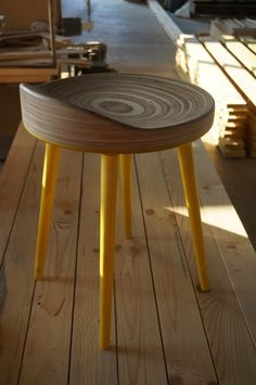 a wooden bench sitting on top of a wooden floor next to other wood planks