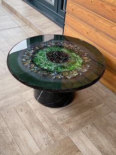 a round glass table with rocks on it