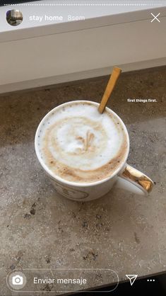 a cappuccino with cinnamon stick in it