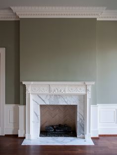 an empty room with a fireplace in it