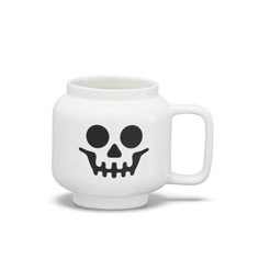 a white mug with a black skull on the front and bottom, sitting in front of a white background