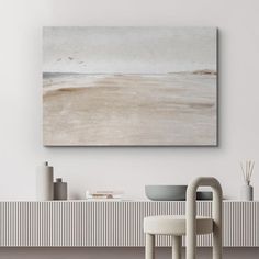 a painting hanging on the wall above a table