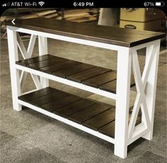 a white and brown table sitting on top of a floor