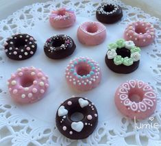 there are many different donuts on the doily