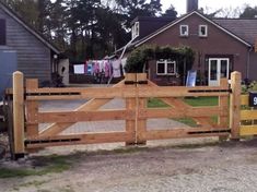 a wooden gate in front of a house