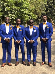 four men in blue suits and yellow bow ties