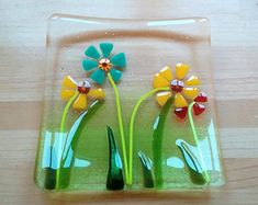 a glass plate with three flowers on it