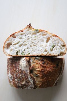 a piece of bread that has been cut in half and is sitting on a white surface