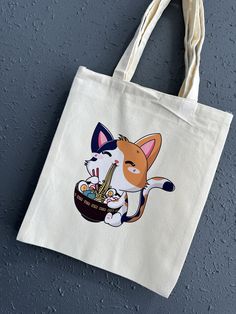 a white tote bag with an image of a cat eating out of a bowl