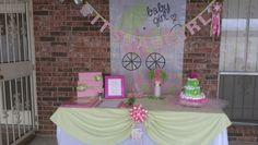 a table with cake and decorations on it in front of a brick wall that says hello kitty