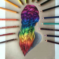 colored pencils are arranged around a drawing of a woman's head with long hair