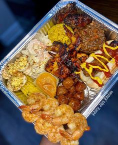 a person holding up a tray with different types of food in it's hands