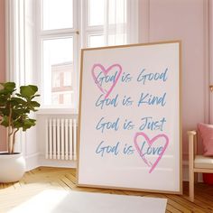 a pink room with a white framed sign and potted plant on the floor next to it