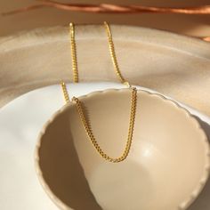 14k gold fill La Mer Chain set in a tan jewelry plate in the sunlight. - Token Jewelry Gold Jewelry Gift, Forever Jewelry, Solid Gold Jewelry, Collared Shirt, Pendant Bracelet, Free Jewelry, Charm Jewelry, Personalized Jewelry, Post Earrings