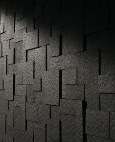 a black and white photo of a clock on the side of a wall with squares