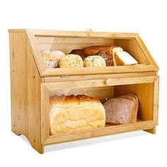 a wooden display case filled with bread and pastries