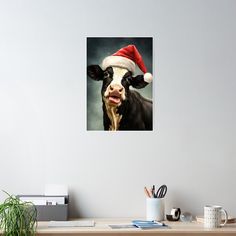 a black and white cow wearing a santa hat