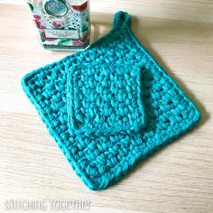 a blue crocheted dishcloth next to a box of tissues