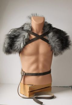 a male mannequin wearing a fur collar and harness