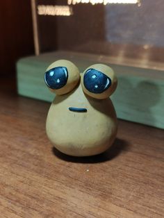 a small ceramic figurine sitting on top of a wooden table