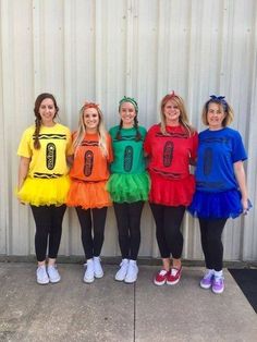 four girls in costumes standing next to each other